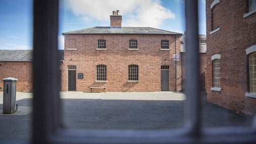 View of the Wash Room across the Womens' Back Court through a window at The Workhouse, Nottinghamshire